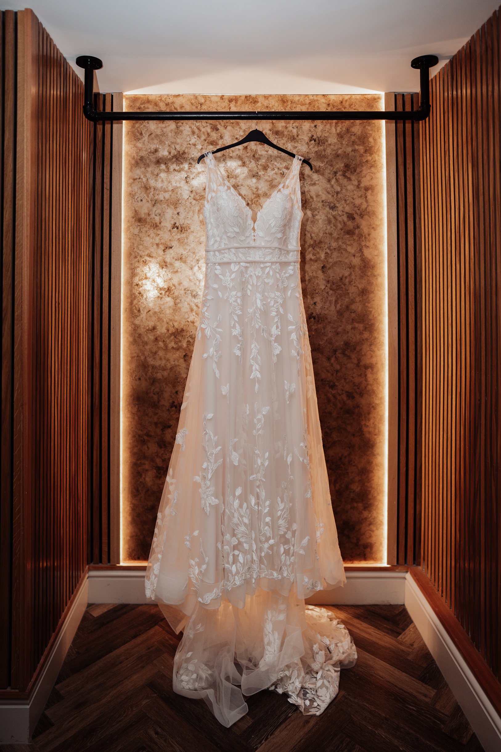 A candid shot of the bride and groom at the altar during their wedding ceremony. They are holding hands, with the groom 
                        looking forward and the bride looking slightly away.